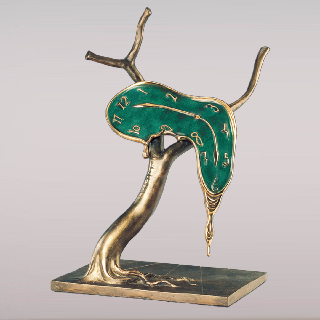 Cette image représente une sculpture de l'artiste Salvador Dalí intitulée "Profil du Temps" Réalisée en bronze à la cire perdue, elle représente une horloge fondue sur un arbres à deux branches, aux couleurs vertes et dorées avec un socle. Elle mesure 51 cm et est exposée à la Galerie Montmartre à Paris, France.